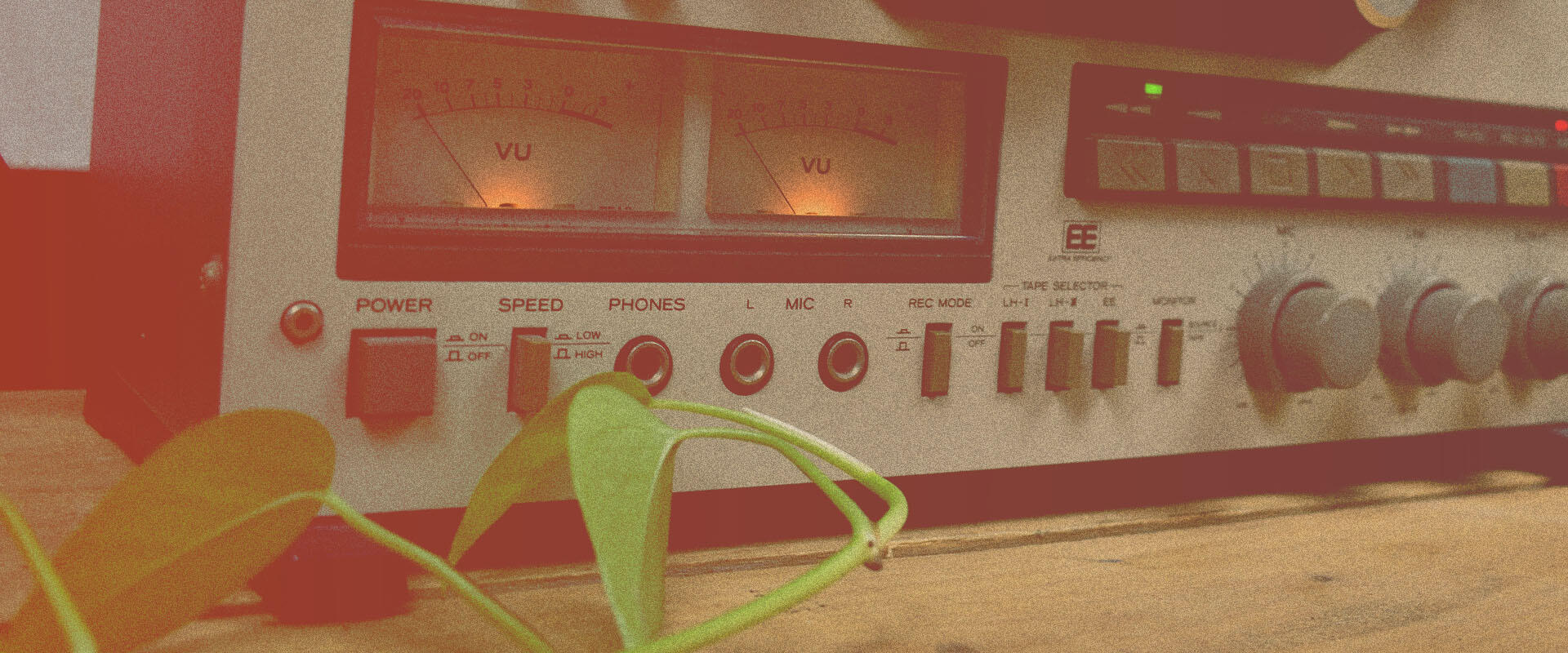 Vintage audio equipment featuring glowing VU meters and retro controls, captured with a film burn effect, illustrating analog tape sample packs and gritty, lo-fi audio textures.