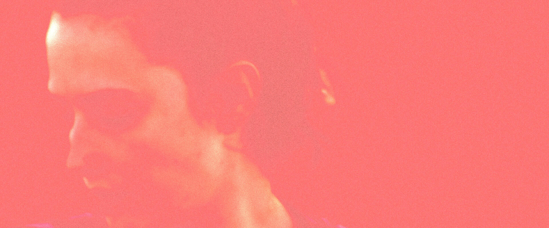 Blurry, warm-toned close-up of a face with a gritty, textured overlay, evoking the analog feel of vintage audio.