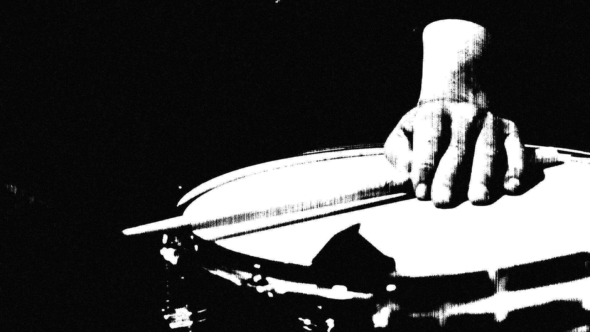 Black and white high-contrast image of a hand holding a drumstick over a drum, evoking a gritty and raw texture.